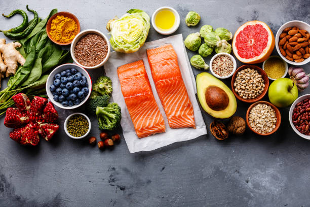 Image of a collection of healthy foods like salmon, blueberries, avacadoes, and garlic